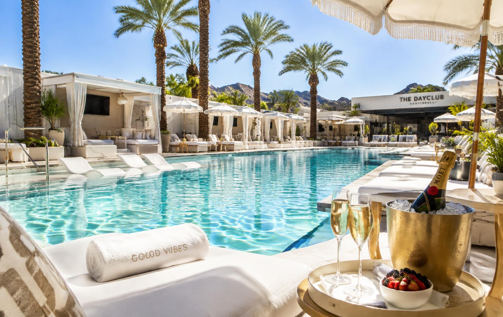 Luxury dayclub pool with cabanas and palms